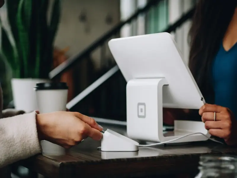 A restaurant owner taking orders at a billing counter