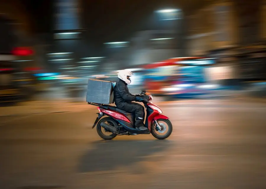 A delivery rider on a scooter at night